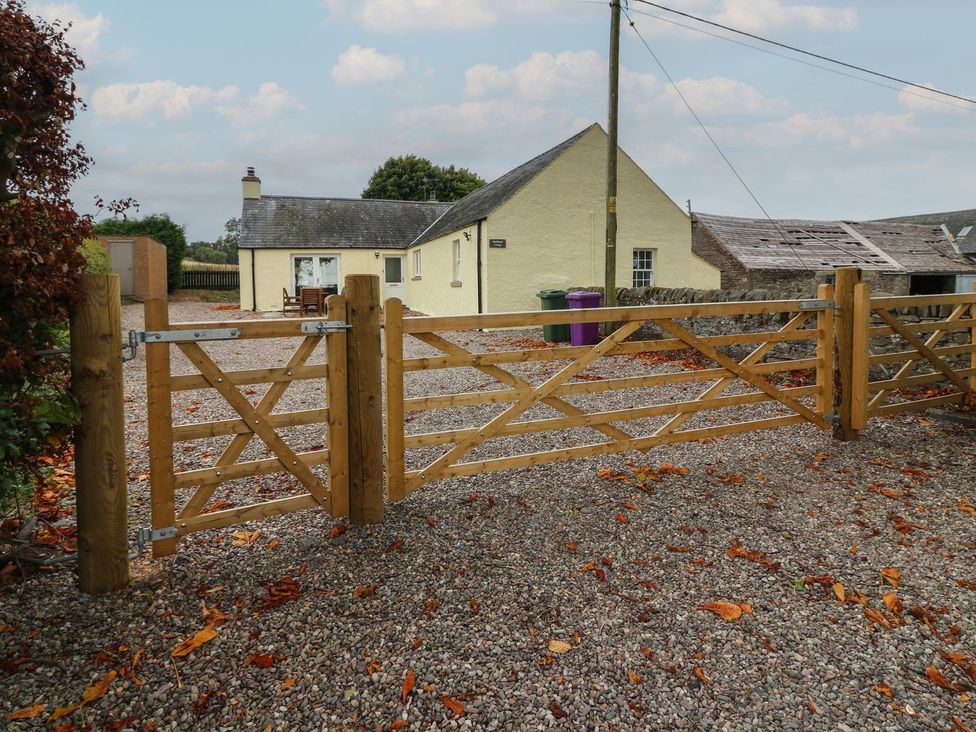A gate at the entrance of a gravel driveway at Bankhead Of Lour Cottage Forfar