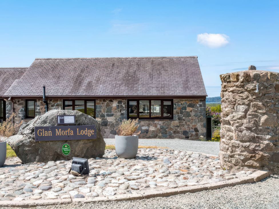 An entrance to Glan Morfa Lodge with landscaping at Glan Morfa Lodge in Llangaffo