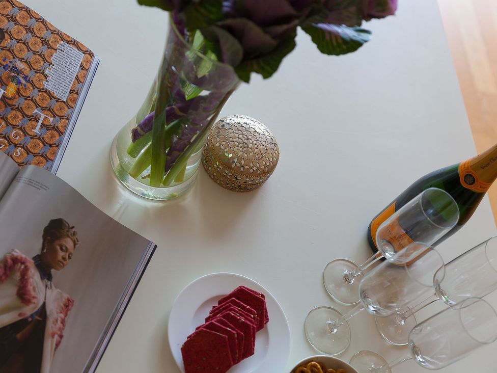 A indoor setting with flowers, snacks and champagne at Mid Air in St. Ives