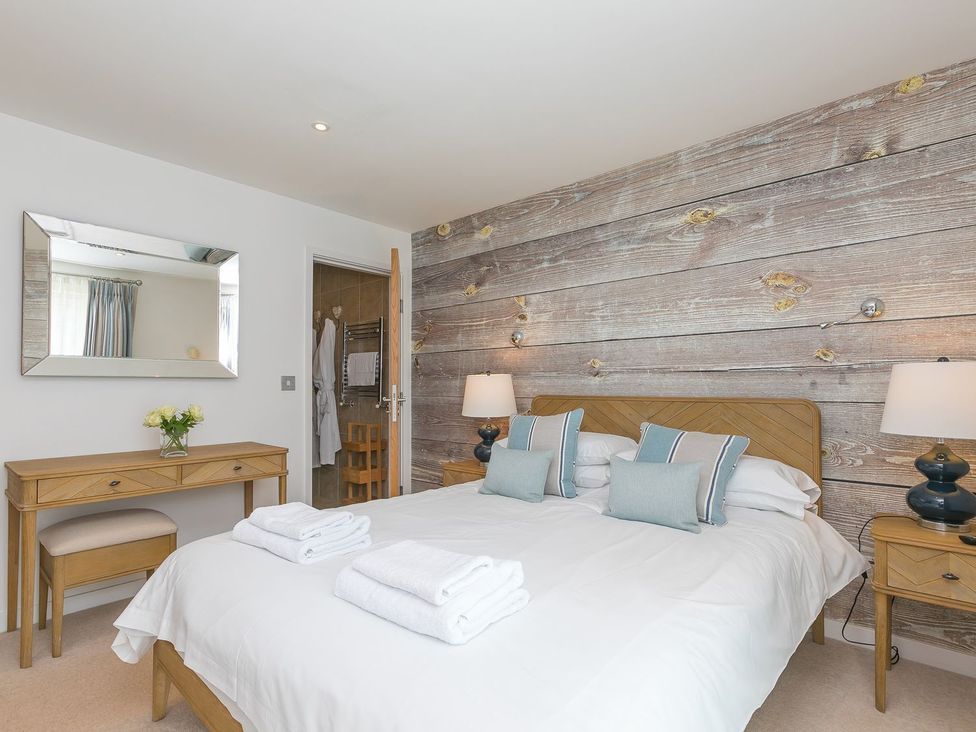 A bedroom with a bed and a mirror at Mid Air St. Ives