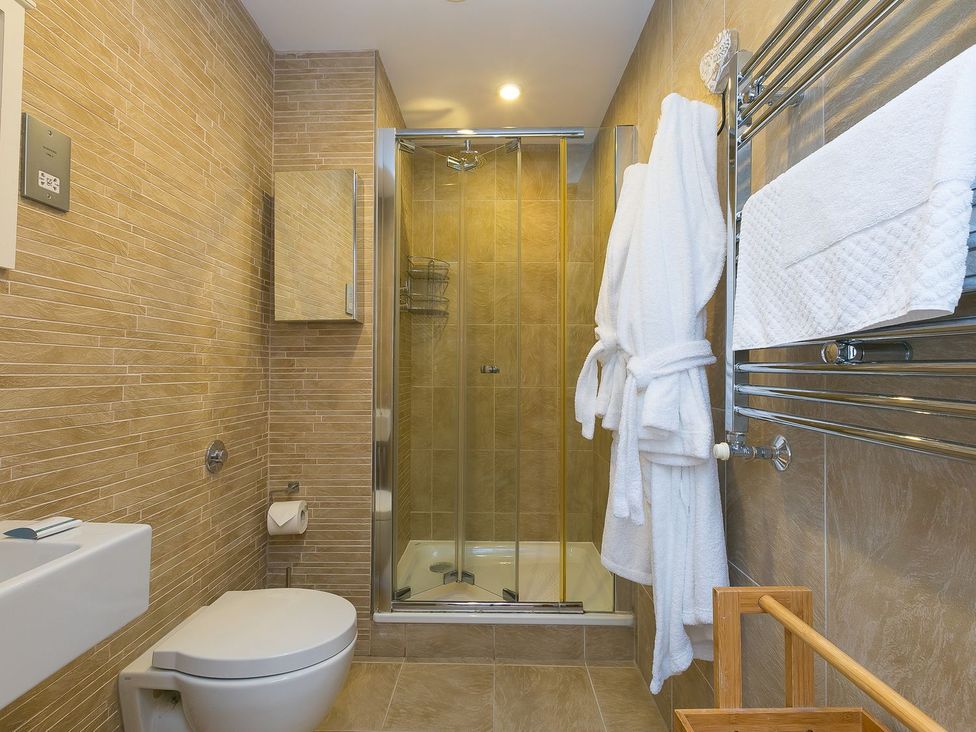 A bathroom with a shower, sink, and toilet at Mid Air in St. Ives