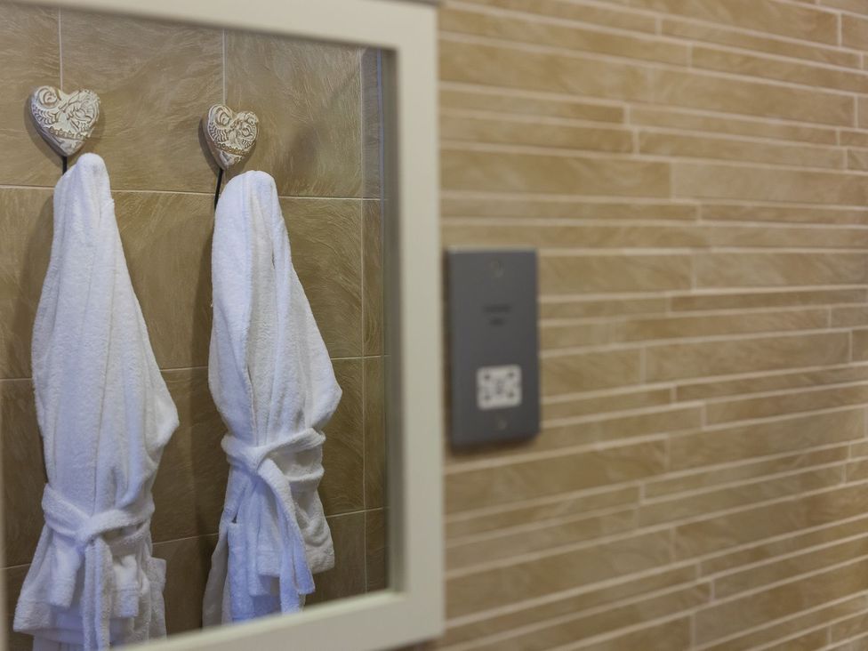 A bathroom with two bathrobes hanging on hooks at Mid Air in St. Ives