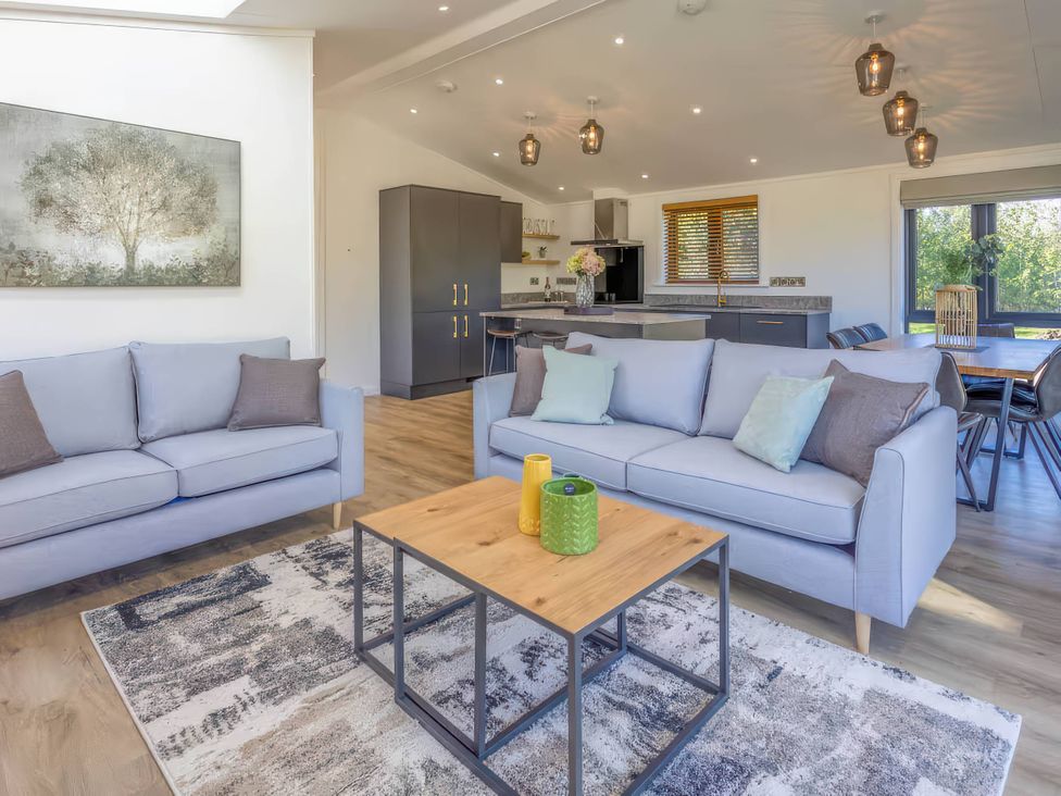 A living room with sofa and coffee table at Isca Lodge - With Decking - Lodge 1 Wombleton