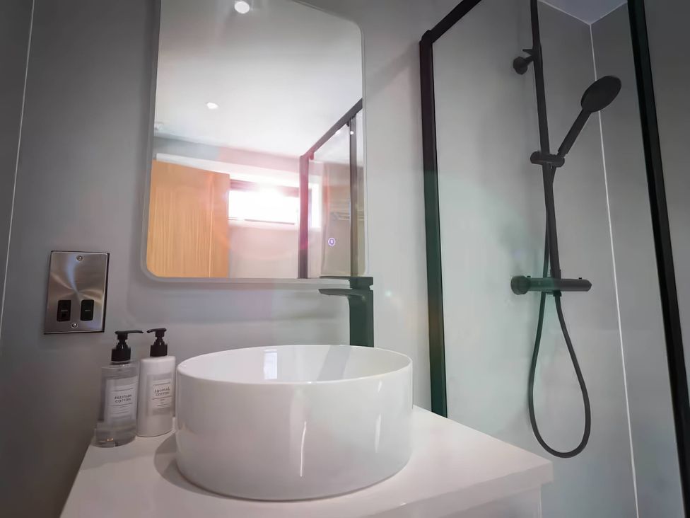 A bathroom with a wash basin and shower at Isca Lodge - With Decking - Lodge 1 Wombleton