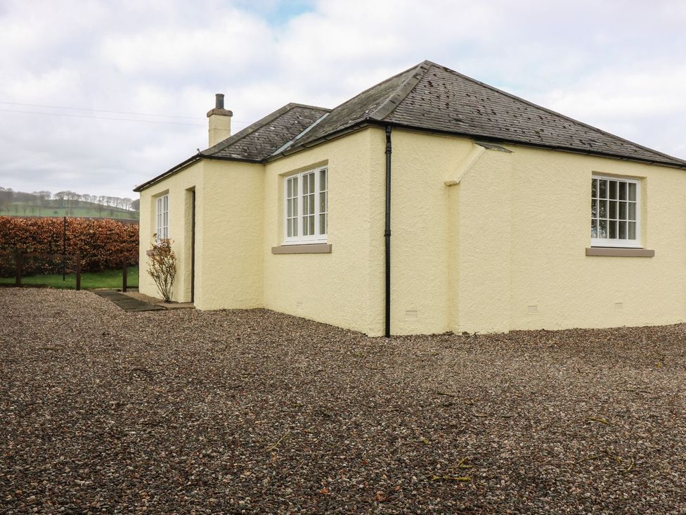A house with windows and a door surrounded by gravel at Bankhead Of Lour Bungalow 