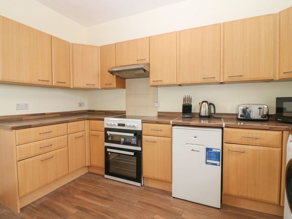 A kitchen with cabinets and appliances at Bankhead Of Lour Bungalow