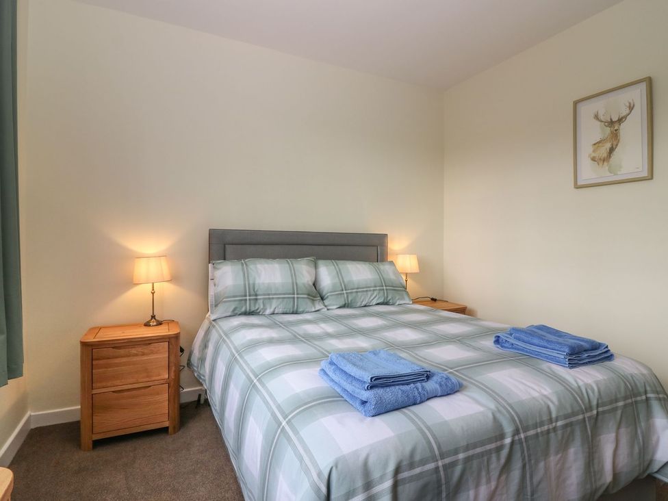 A bedroom with a bed and bedside tables at Bankhead Of Lour Bungalow