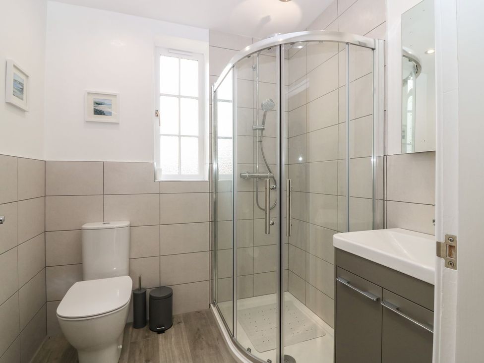 A bathroom with a shower, toilet, and sink at Bankhead Of Lour Bungalow