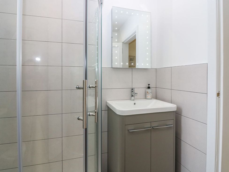 A bathroom with a shower and a vanity unit at Bankhead Of Lour Bungalow