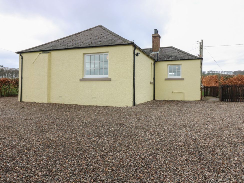 A house with gravel driveway and fence at Bankhead Of Lour Bungalow
