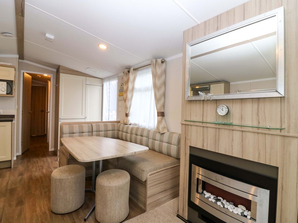 A living room with a table and sofa at Caravan number 77