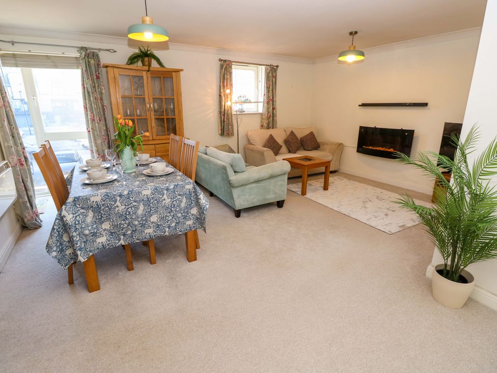 A living room with a dining area and sofa at 53 Orchard Place