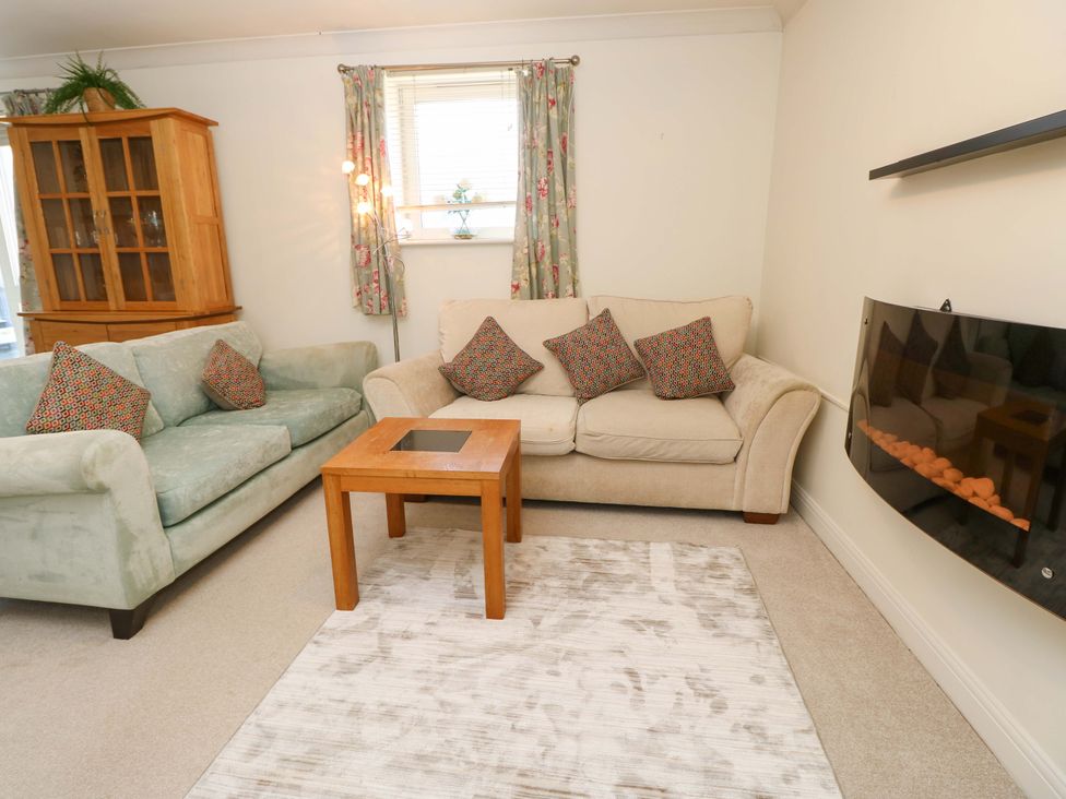 A living room with sofas and a coffee table at 53 Orchard Place