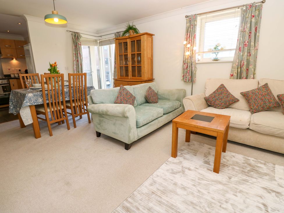 A living room with seating and a dining area at 53 Orchard Place