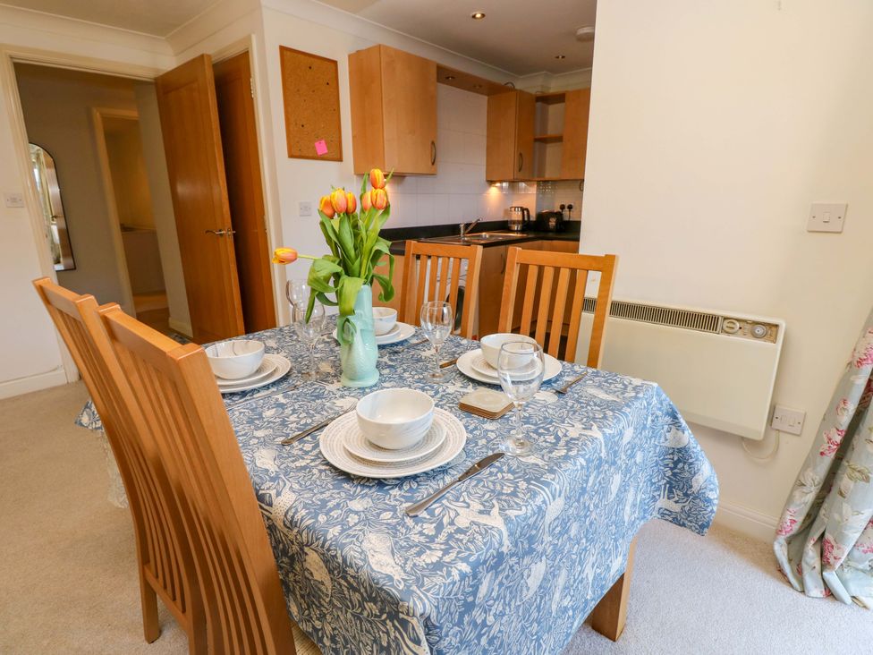 A dining room with a table set for four at 53 Orchard Place 
