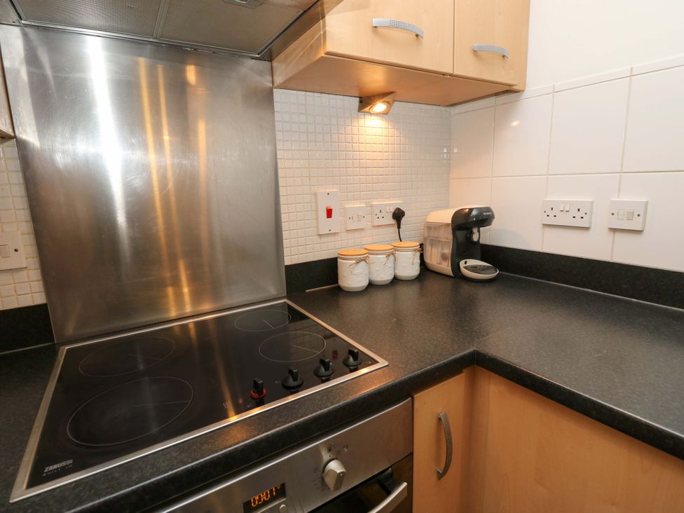 A kitchen with electric hob and cabinets at 53 Orchard Place
