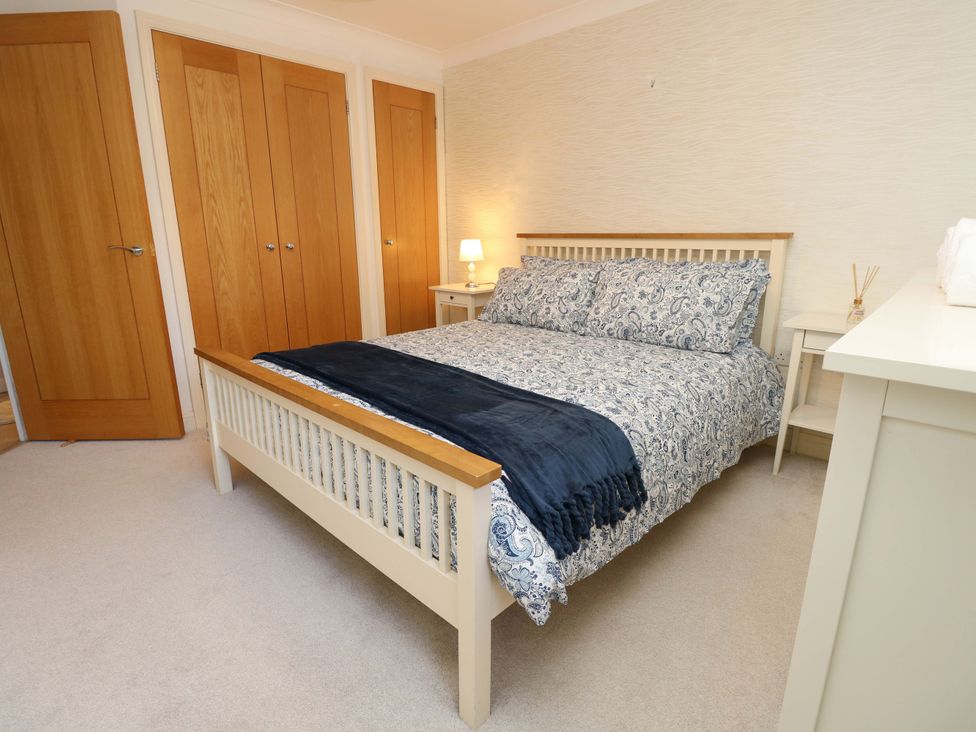 A bedroom with a bed and bedside table at 53 Orchard Place