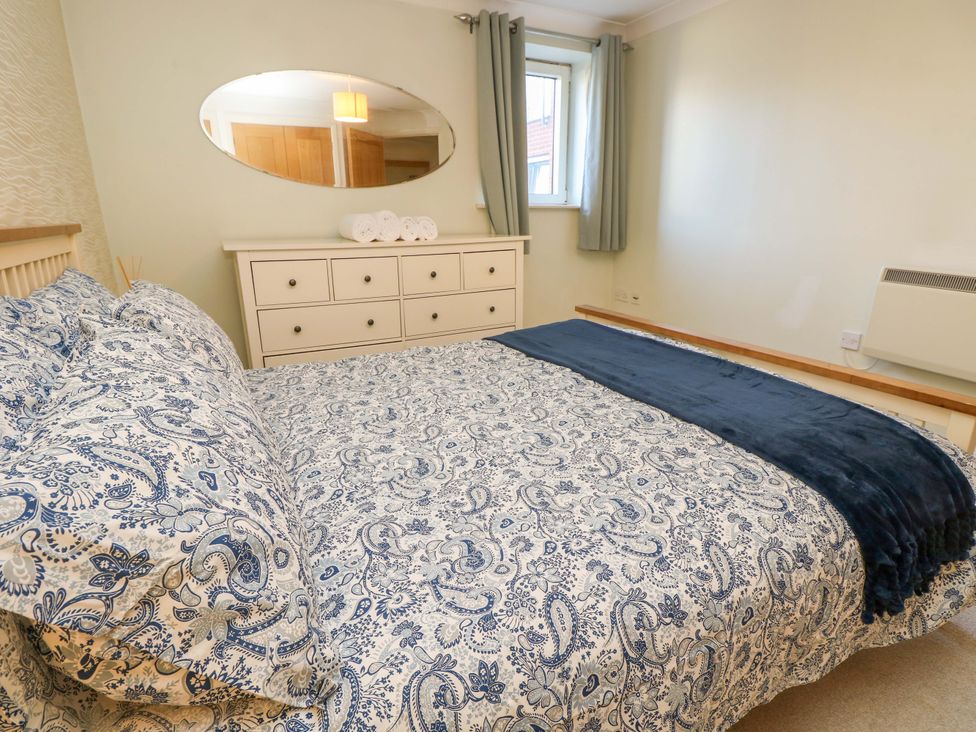 A bedroom with a bed and dresser at 53 Orchard Place