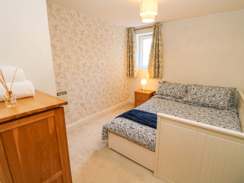 A bedroom with a bed and bedside table at 53 Orchard Place