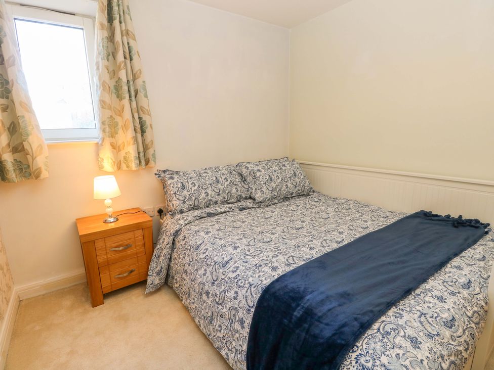 A bedroom with a bed and bedside table at 53 Orchard Place