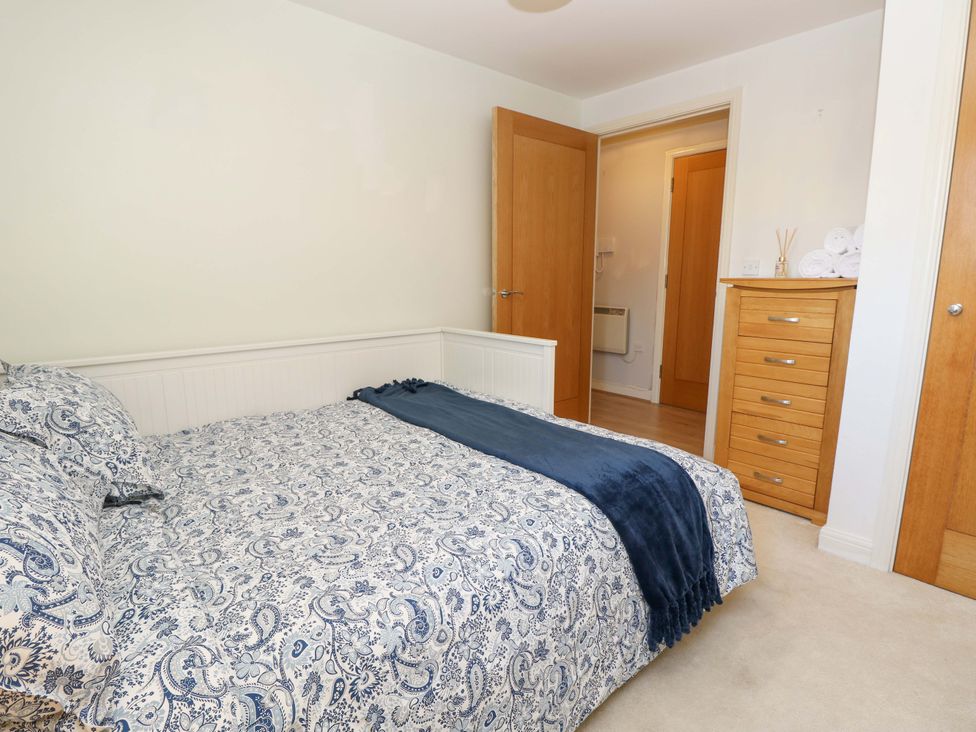 A bedroom with a bed and dresser at 53 Orchard Place
