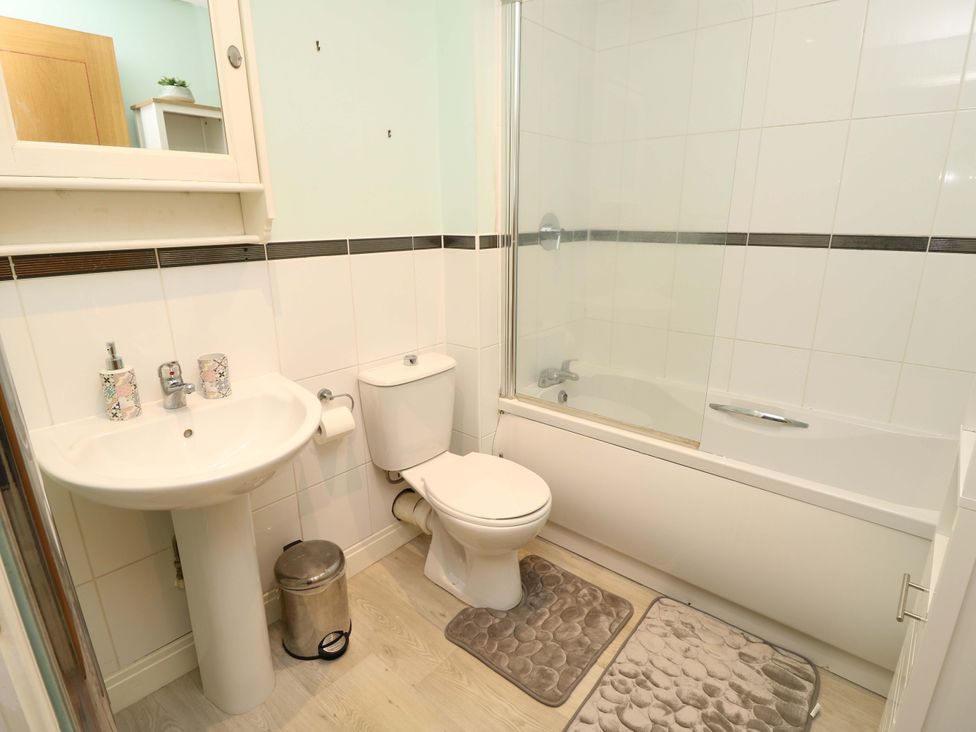 A bathroom with a sink, toilet, and bathtub at 53 Orchard Place 