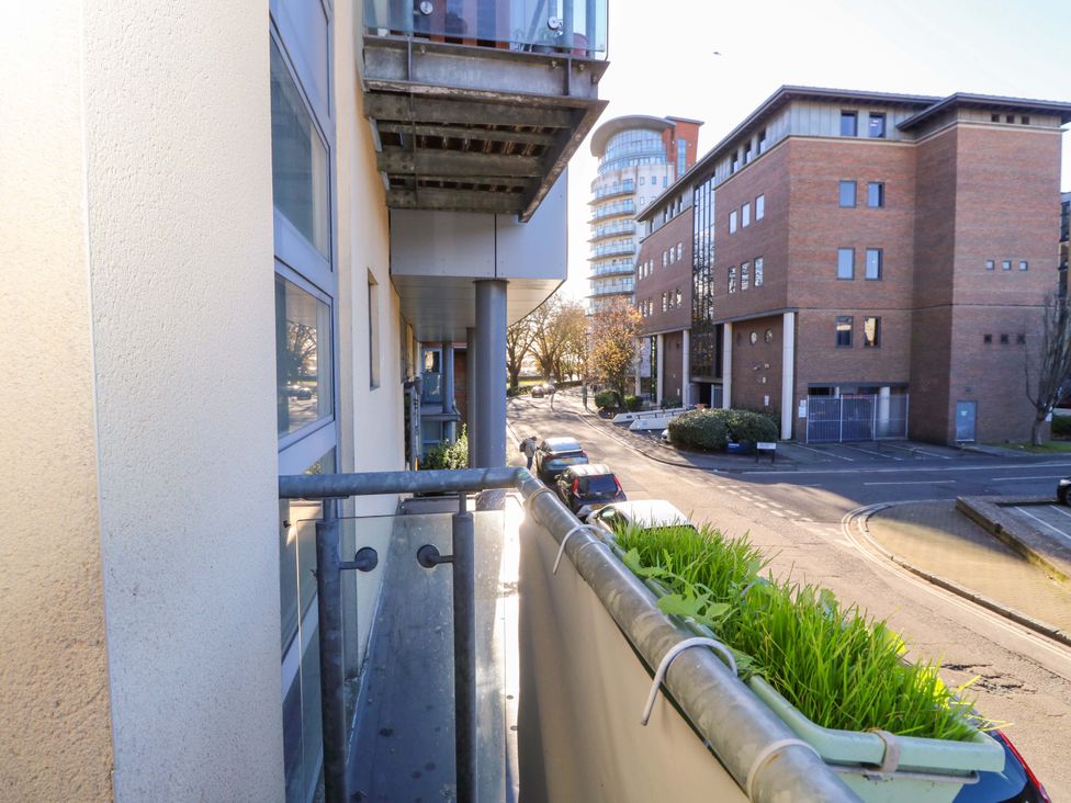 A balcony view of buildings and a road at 53 Orchard Place