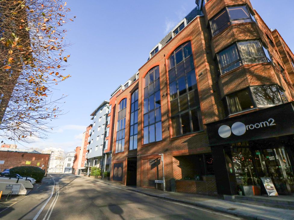 A building with large windows and a sign at room2 in an outdoor setting