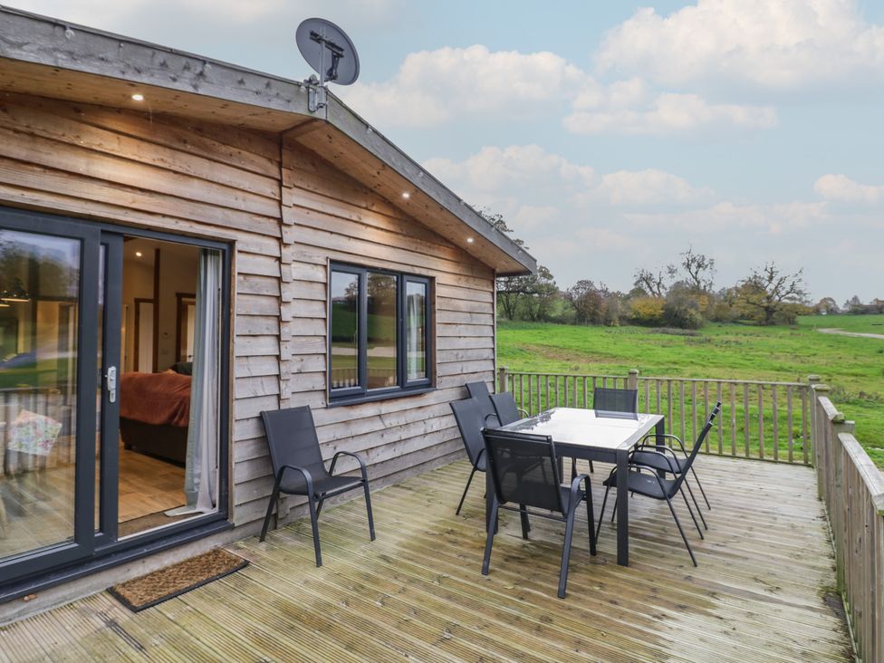 A deck with a table and chairs at Oak Lodge Admaston near Abbots Bromley