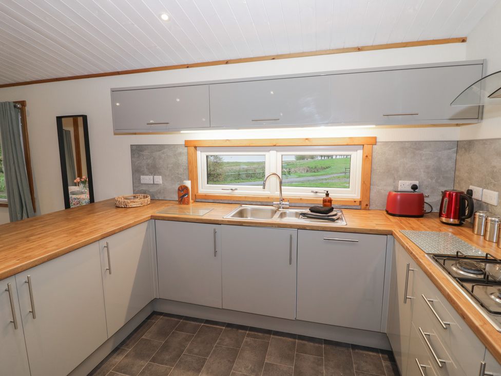 A kitchen with a sink and appliances at Oak Lodge in Admaston near Abbots Bromley