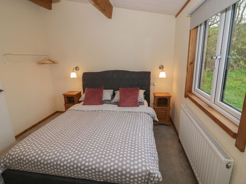 A bedroom with a bed and nightstands at Oak Lodge Admaston near Abbots Bromley
