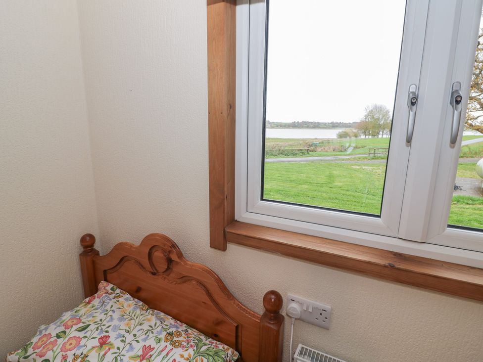 A bedroom with a window showing a view at Oak Lodge in Admaston near Abbots Bromley