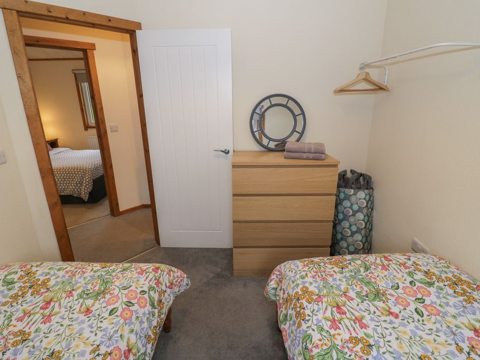 A bedroom with two beds and a dresser at Oak Lodge in Admaston near Abbots Bromley