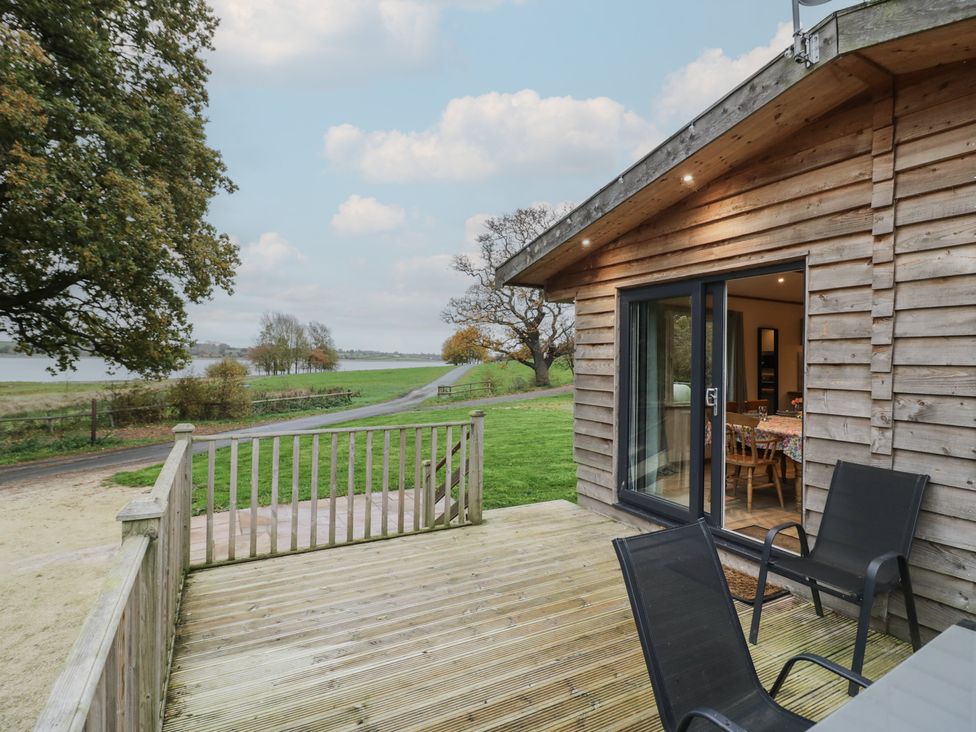 An outdoor seating area with a table and chairs at Oak Lodge Admaston near Abbots Bromley