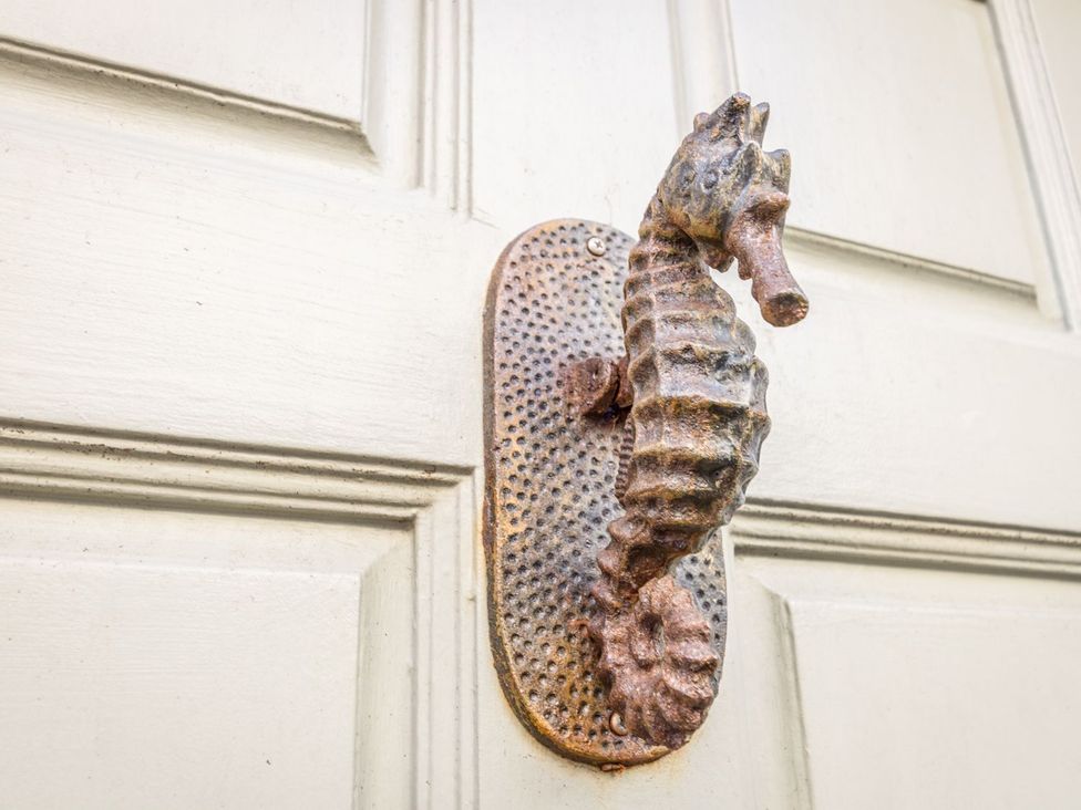 A seahorse door handle on a door at Seahorse Cottage in Weymouth