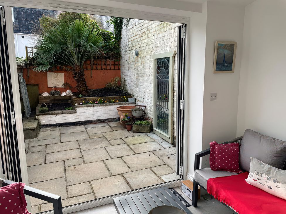 A seating area looking out to a garden at Seahorse Cottage Weymouth