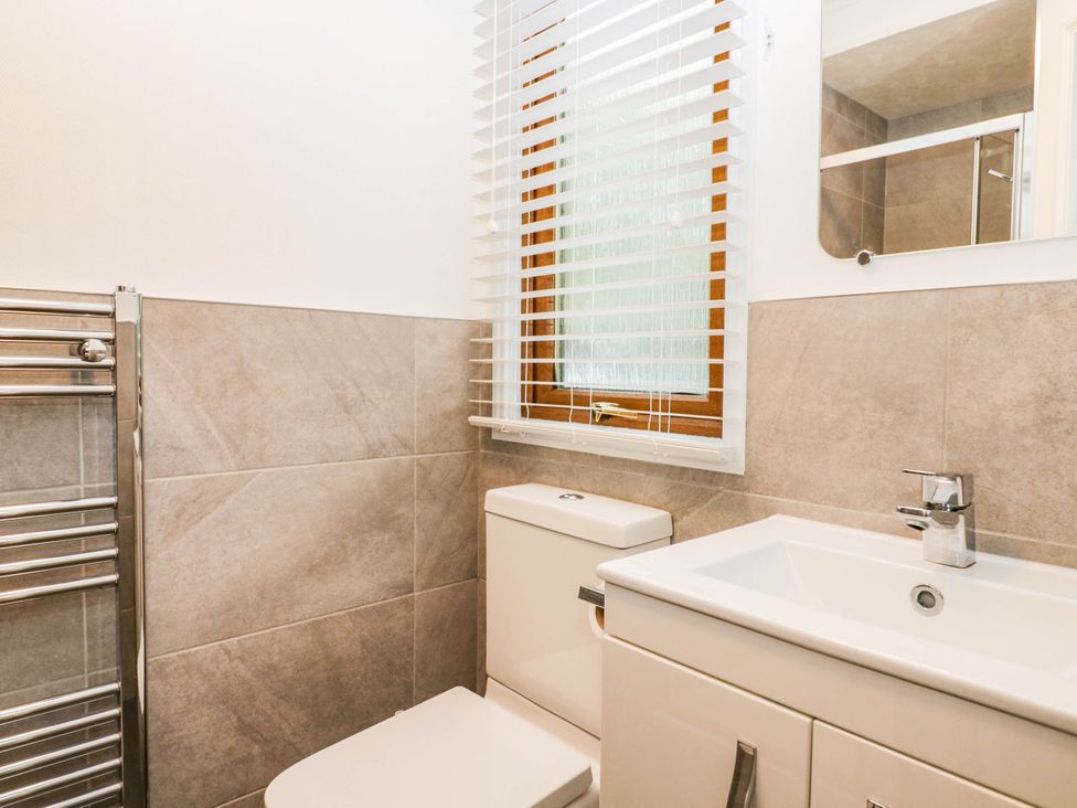 A bathroom with a toilet and sink at Terabitha Lodge Troutbeck