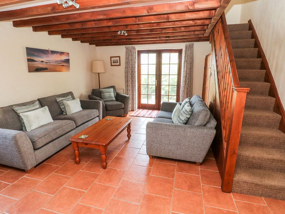 A living room with a sofa and coffee table at Ty Fferm in Newport