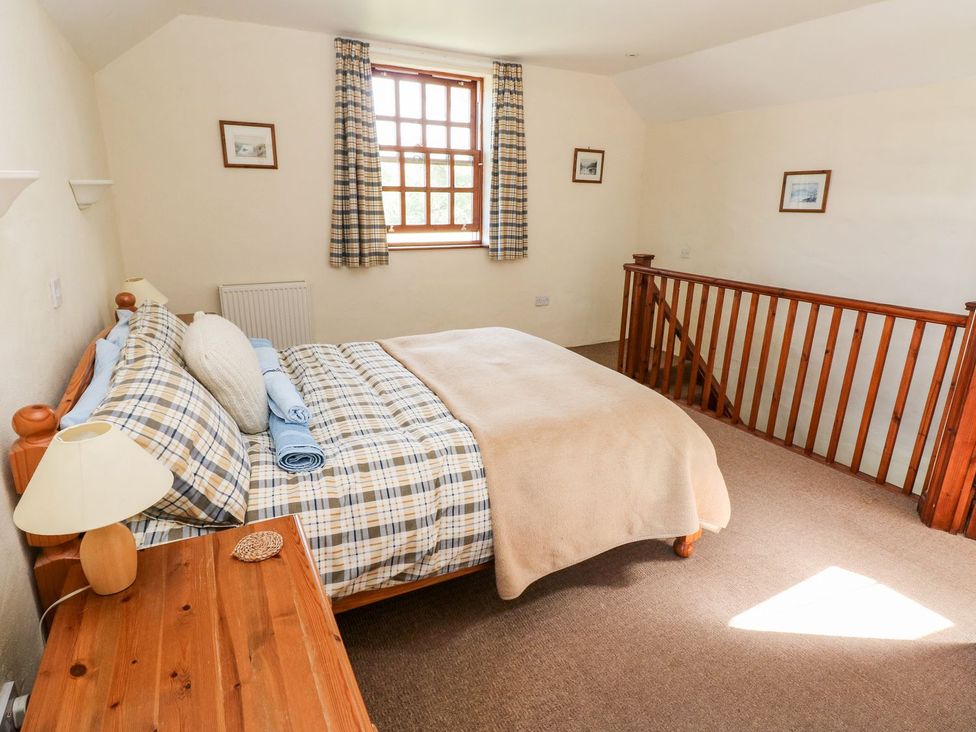 A bedroom with a bed and furniture at Ty Fferm in Newport