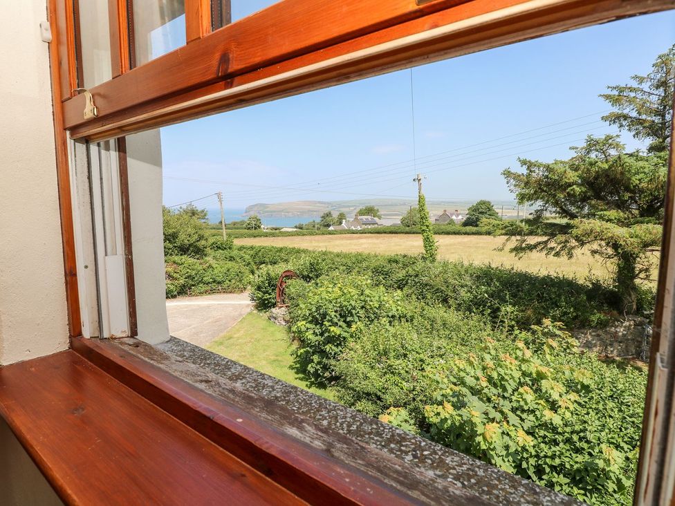 View from a window showing a field and buildings at Ty Fferm Newport