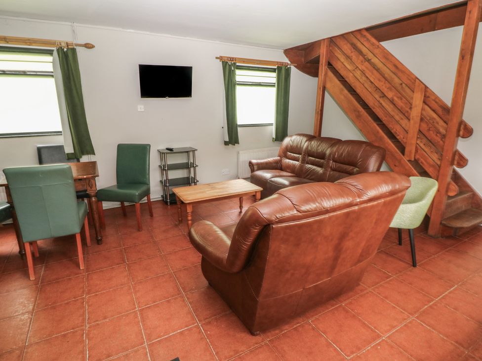 A living room with seating area and dining table at Cabin No. 13 - Salt and Fern Cabins Goytre near Port Talbot