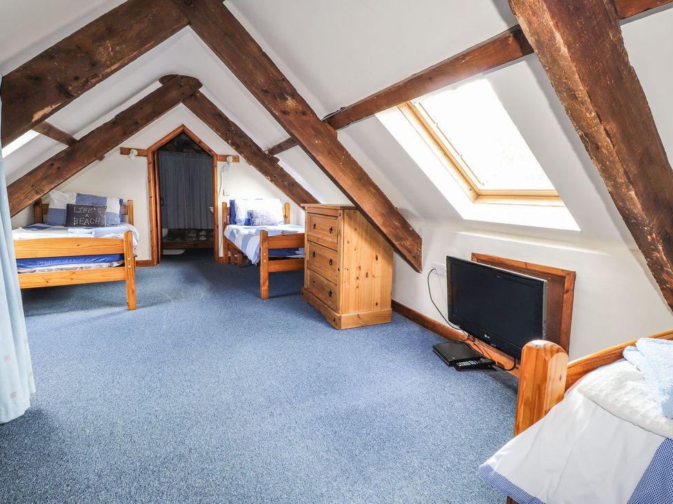 A bedroom with two beds and a dresser at Ty Felin in Newport