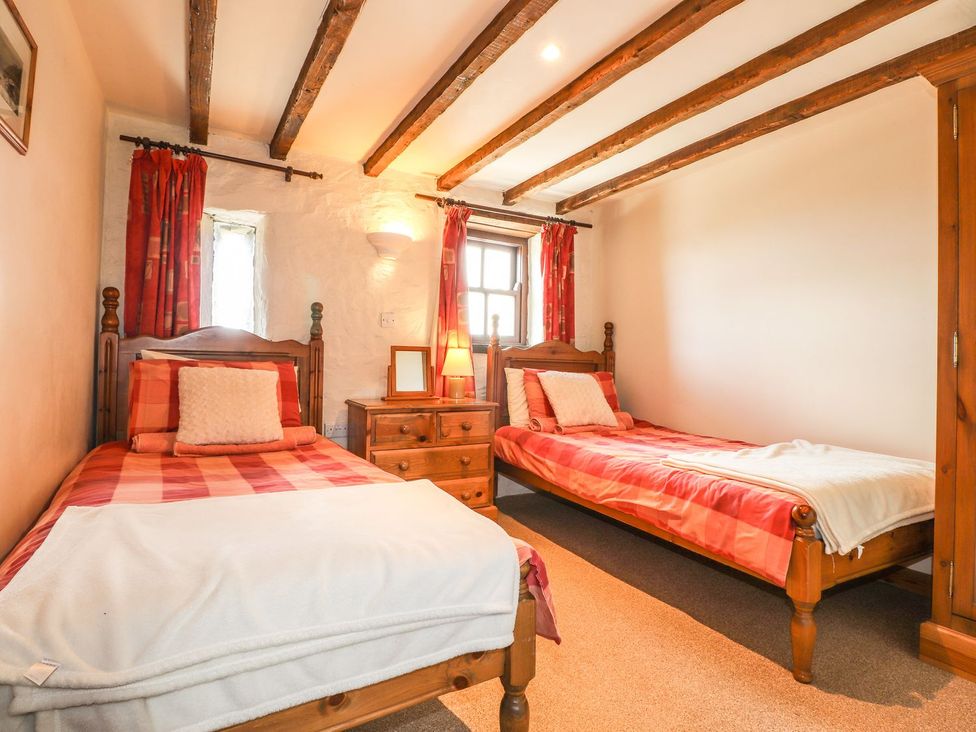 A bedroom with two beds and a window at Ty Felin Newport