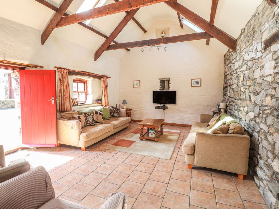 A living room with a television and seating area at Ty Gwartheg Newport