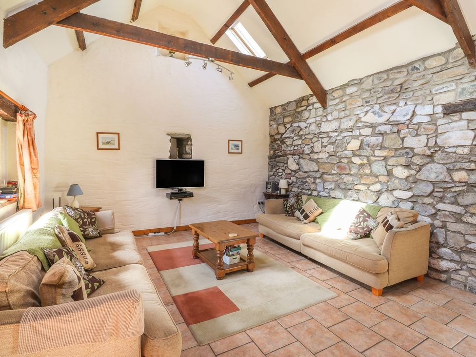 A living room with a sofa and TV at Ty Gwartheg in Newport