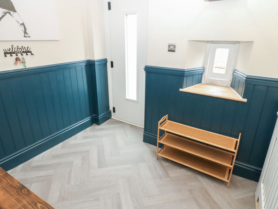 A hallway with a door and a shelf at Broadwath Old House in Heads Nook
