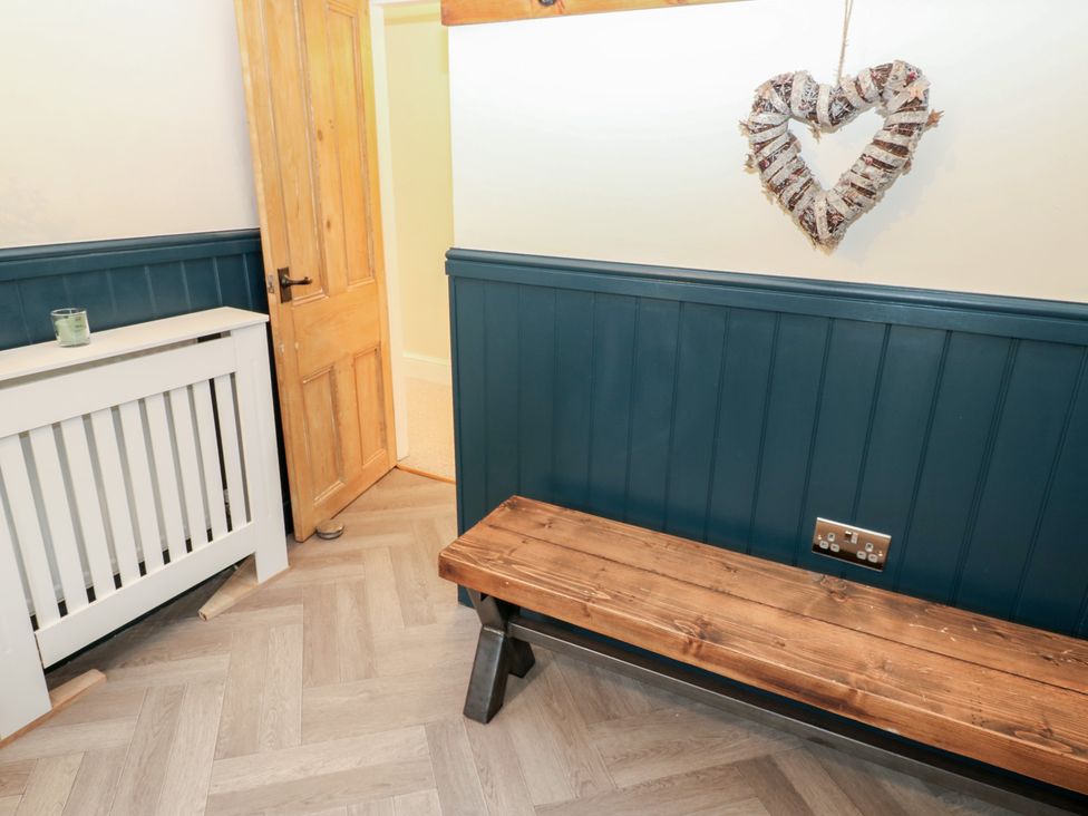 A hallway with a bench and radiator at Broadwath Old House in Heads Nook