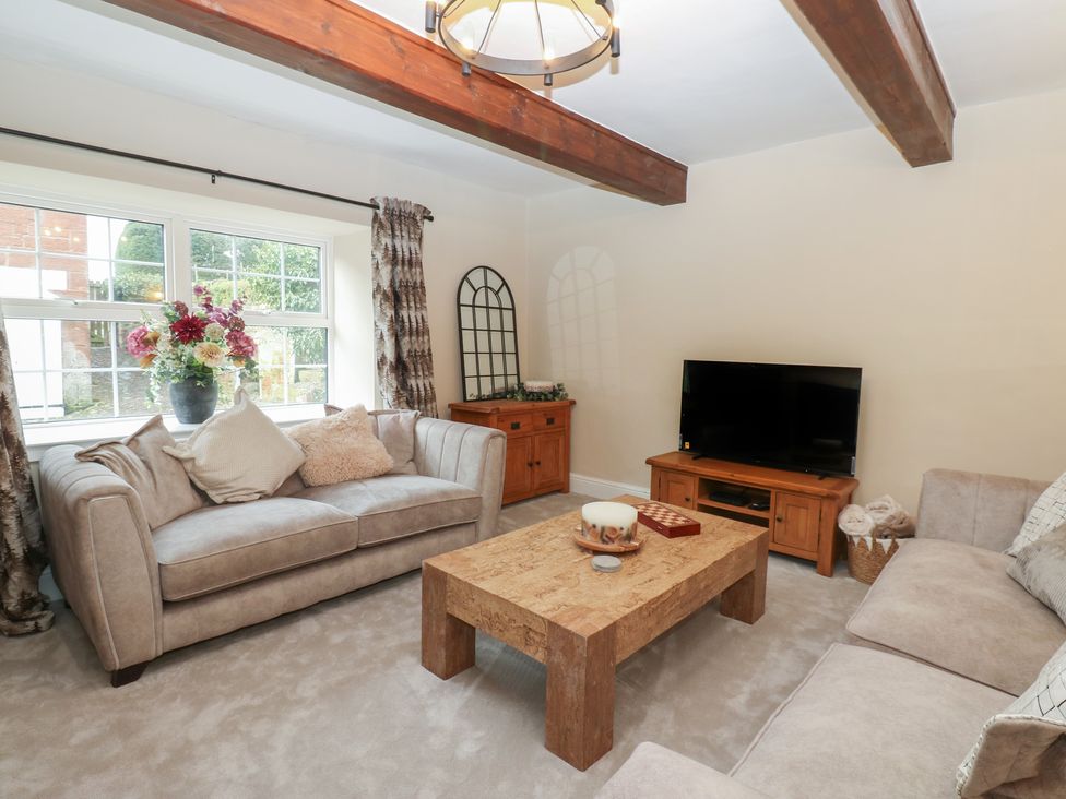 A living room with a coffee table and sofa at Broadwath Old House in Heads Nook