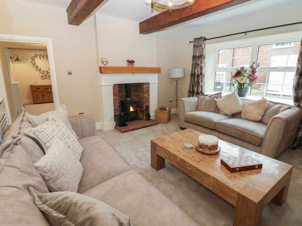 A living room with a sofa and coffee table at Broadwath Old House in Heads Nook