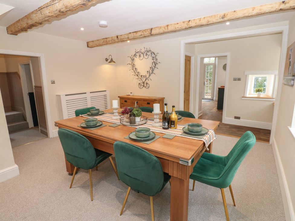 A dining room with a table set for a meal at Broadwath Old House in Heads Nook